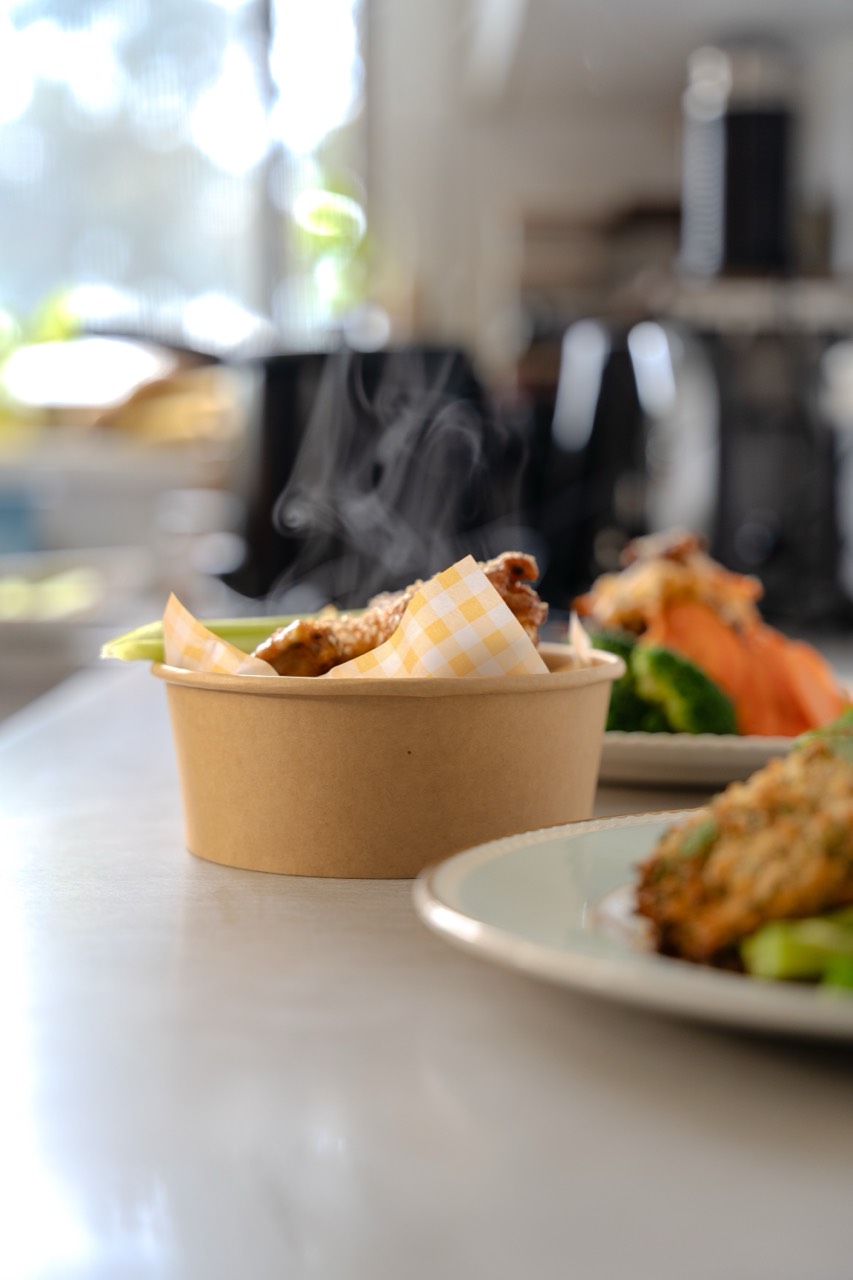 Steaming kraft takeaway bowl of home-cooked food, fresh from the kitchen